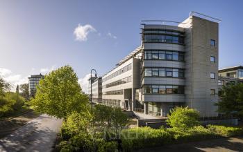 Modern office building located at Boeingavenue 223 – 239, Schiphol Rijk, with multiple stories and large windows, surrounded by green foliage, ideal for office space rental.