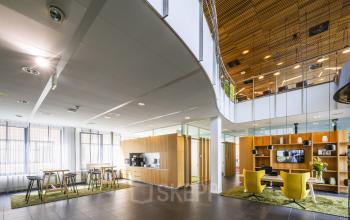 Spacious interior of office space rental at Boeingavenue 223 – 239 in Schiphol Rijk, featuring modern furniture, a kitchenette, and open work areas.