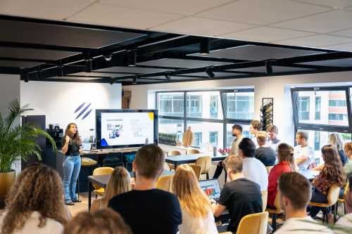 Spacious office interior at Beechavenue 30, Schiphol Rijk, with a group of people attending a presentation in a modern workspace setting.