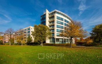Modern office building at Beechavenue 54-62 in Schiphol offering bright office space rental opportunities amidst lush greenery.
