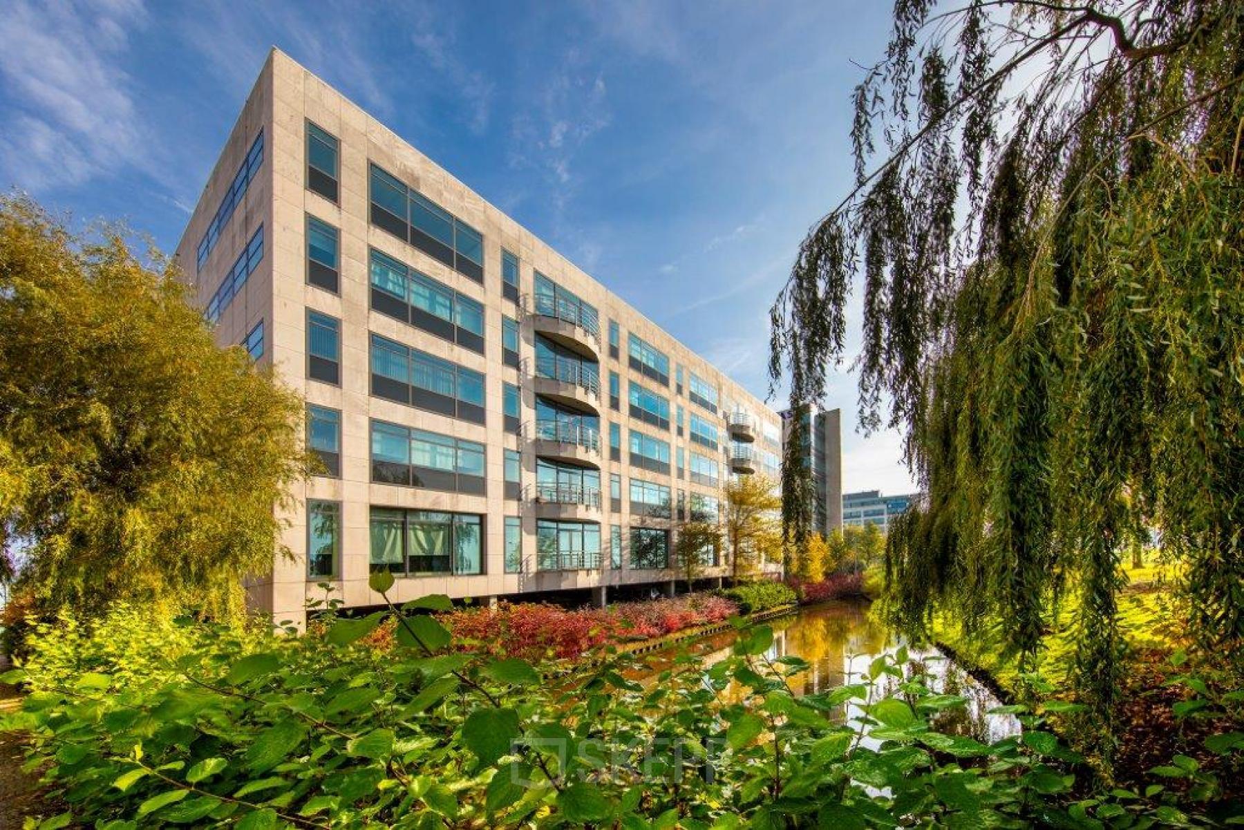 Exterior view of Beechavenue 54-62 office building in Schiphol Rijk, Schiphol, showcasing modern architecture and lush surroundings. Ideal for office space rental.