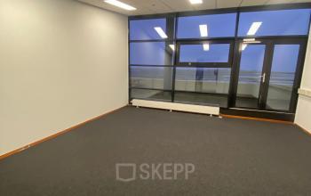 Spacious unfurnished office interior with large windows at 200 Milaanstraat, Sittard, ideal for office space rental.