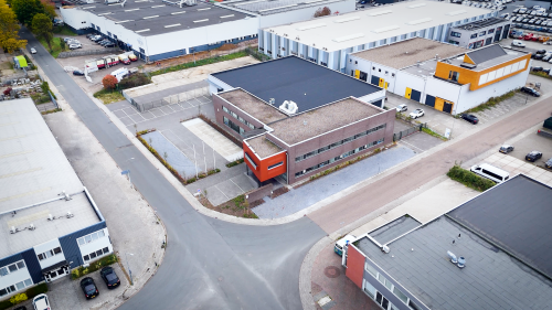Aerial view of office building at Fischerpad 106, Sittard, ideal for office space rental. The building features a modern design with nearby parking options.