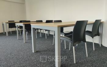 Simple furnished office space with tables and chairs at Dr. Nolenslaan 157, Sittard, ideal for office space rental.