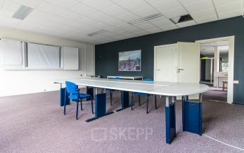 Bright office space at Nusterweg 63, Sittard, featuring multiple tables and chairs ideal for office space rental needs.