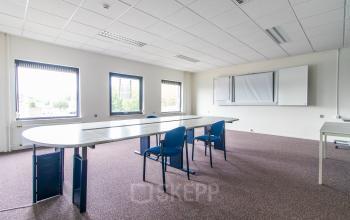 Bright office space available for rental at Nusterweg 63, Sittard, featuring desks and chairs in a functional setup for productive work.