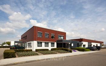 Exterior view of office space rental at Nusterweg 63, Sittard, showing a modern building with ample parking.