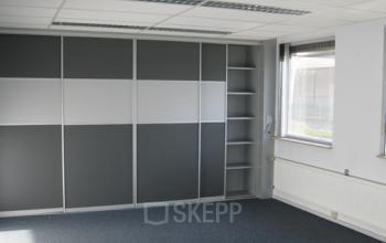 Bright office space with ample natural light and built-in storage shelves, located at Nusterweg 63 in Sittard, ideal for those looking to rent office space in a functional and accessible location.