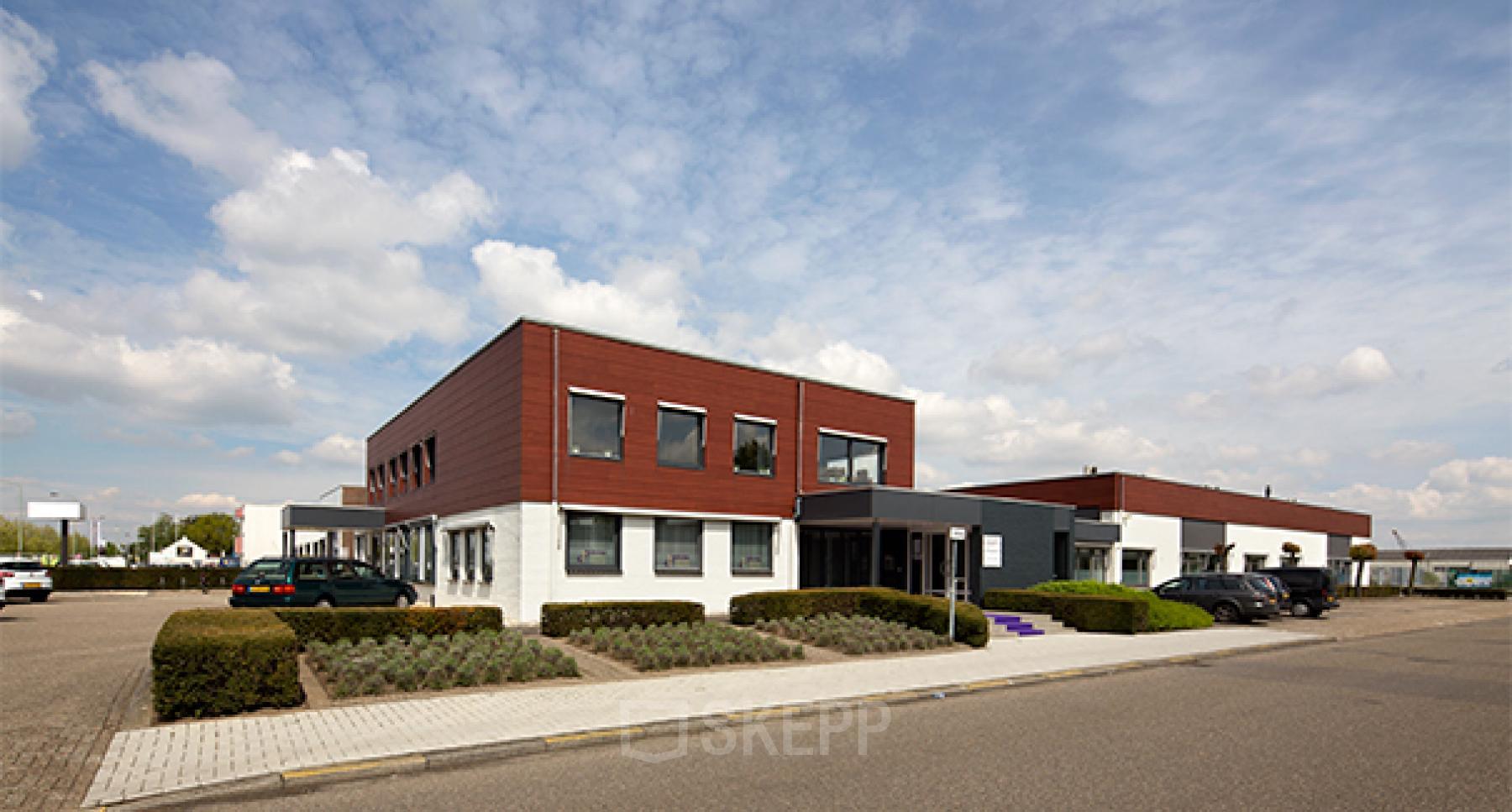 Exterior view of a modern office space rental at Nusterweg 63, Sittard, with parking spaces and a two-story building.