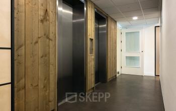 Interior corridor with a modern elevator at Curieweg 9, Spijkenisse, ideal for office space rental.