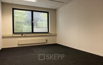 Unfurnished office space with a large window at Curieweg 9, Spijkenisse, available for rental.