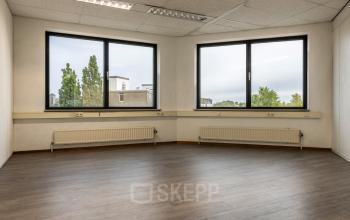 Unfurnished office space with large windows at Curieweg 9, Spijkenisse, available for rent.