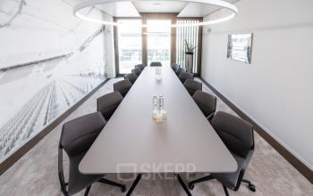Moderner Konferenzraum zur Büromiete in der Königstraße 35, Stuttgart Mitte. Ein langer Tisch mit Stühlen und Beleuchtung sorgt für eine ideale Umgebung für Meetings.