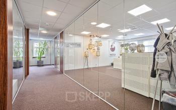 Modern office interior with glass walls and stylish decor at Bredaseweg 8, Breda Terheijden, ideal for office space rental, featuring a reception area within a professional environment.