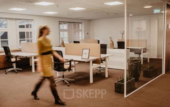 Modern office space at Bredaseweg 8, Breda Terheijden, featuring stylish workstations with office chairs and glass partitions, ideal for business professionals seeking office space rental in a contemporary setting.