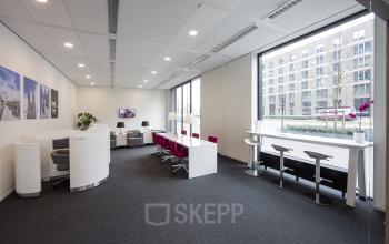 Modern office space rental at Hart van Brabantlaan 12-16, Tilburg, featuring a well-lit interior with contemporary furnishings and a view of the surroundings.