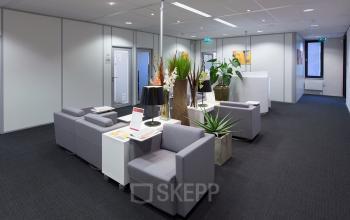 Modern office space rental at Hart van Brabantlaan 12-16 in Tilburg with comfortable seating and sleek decor.
