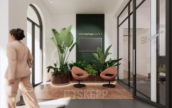 Modern office interior at Moreelsepark 1, Utrecht Central Station, featuring a stylish reception area with plants and seating, ideal for office space rental.