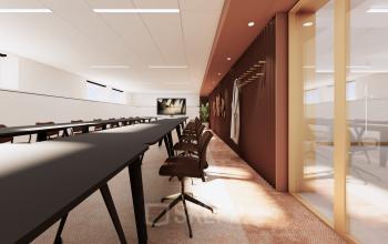 Modern conference room at Moreelsepark 1 in Utrecht Central Station, featuring sleek tables and comfortable chairs, ideal for office space rental. The room is well-lit and designed for productivity.