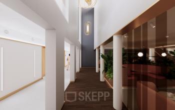 Spacious and elegant hallway with modern light fixtures and wooden flooring in an office at Moreelsepark 1, ideal for office space rental in Utrecht Central Station. Features stylish decor and natural lighting.