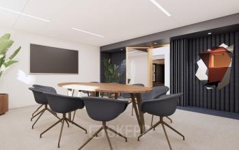 Modern office space at Moreelsepark 1, Utrecht, featuring a sleek conference room with a wooden table and black chairs, ideal for business meetings. Contemporary design elements create an inviting atmosphere for office space rental.