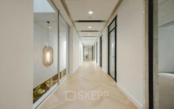 Bright hallway at Moreelsepark 1, Utrecht Central Station, ideal for office space rental with sleek design and modern lighting.
