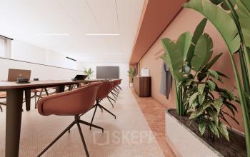 Modern conference room at Moreelsepark 1, Utrecht Central Station, featuring sleek furnishings and greenery, available for office space rental.