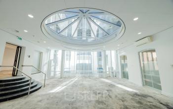 Spacious office interior at Moreelsepark 1, Utrecht Central Station, featuring a large skylight, perfect for office space rental.
