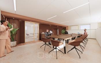 Modern conference room at Moreelsepark 1, Utrecht Central Station featuring a long wooden table and comfortable seating, ideal for office space rental. Professionals engaged in a business meeting.