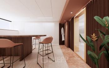 Modern office space with stylish furniture at Moreelsepark 1, featuring high stools and a sleek wooden table, perfect for rent. The warm ambiance enhances productivity and collaboration.