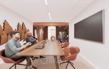 A modern conference room at Moreelsepark 1, Utrecht Central Station featuring sleek wooden table, stylish chairs, large wall-mounted screen, and artistic wall decor. Ideal for office space rental activities.