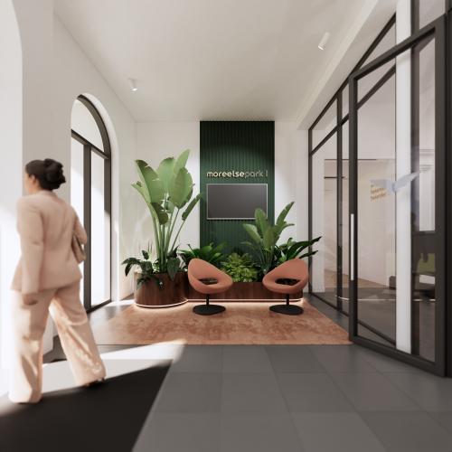 Modern office interior at Moreelsepark 1, Utrecht Central Station, featuring a stylish reception area with plants and seating, ideal for office space rental.