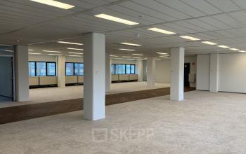 Spacious office interior at Jaarbeursplein 22, Utrecht Central Station, featuring open floor plan with ample natural light, suitable for office space rental.