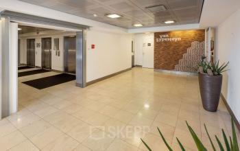 Spacious entrance area at Jaarbeursplein 22, Utrecht Central Station, featuring elevators and modern design. Ideal for office space rental.