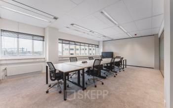 A spacious office in Utrecht Central Station at Leidseveer 2-10, featuring desks and chairs suitable for office space rental.