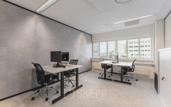 Furnished office space at Leidseveer 2-10, Utrecht Central Station, featuring desks and chairs with computers for office space rental.