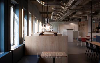Office space with wooden partitioned desks and modern lighting at Arthur van Schendelstraat 650, Utrecht Central Station.