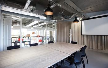 Conference room in an office to rent at Arthur van Schendelstraat 650, Utrecht Central Station, featuring a spacious table, chairs, and modern decor.