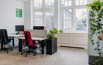 Bright office space at Kromme Nieuwegracht 3, Utrecht Center, furnished with desks, chairs, and indoor plants.