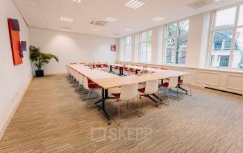 Bright, spacious conference room with a U-shaped table arrangement, modern decor, large windows in the office space rental at Kromme Nieuwegracht 3, Utrecht Center, Utrecht.