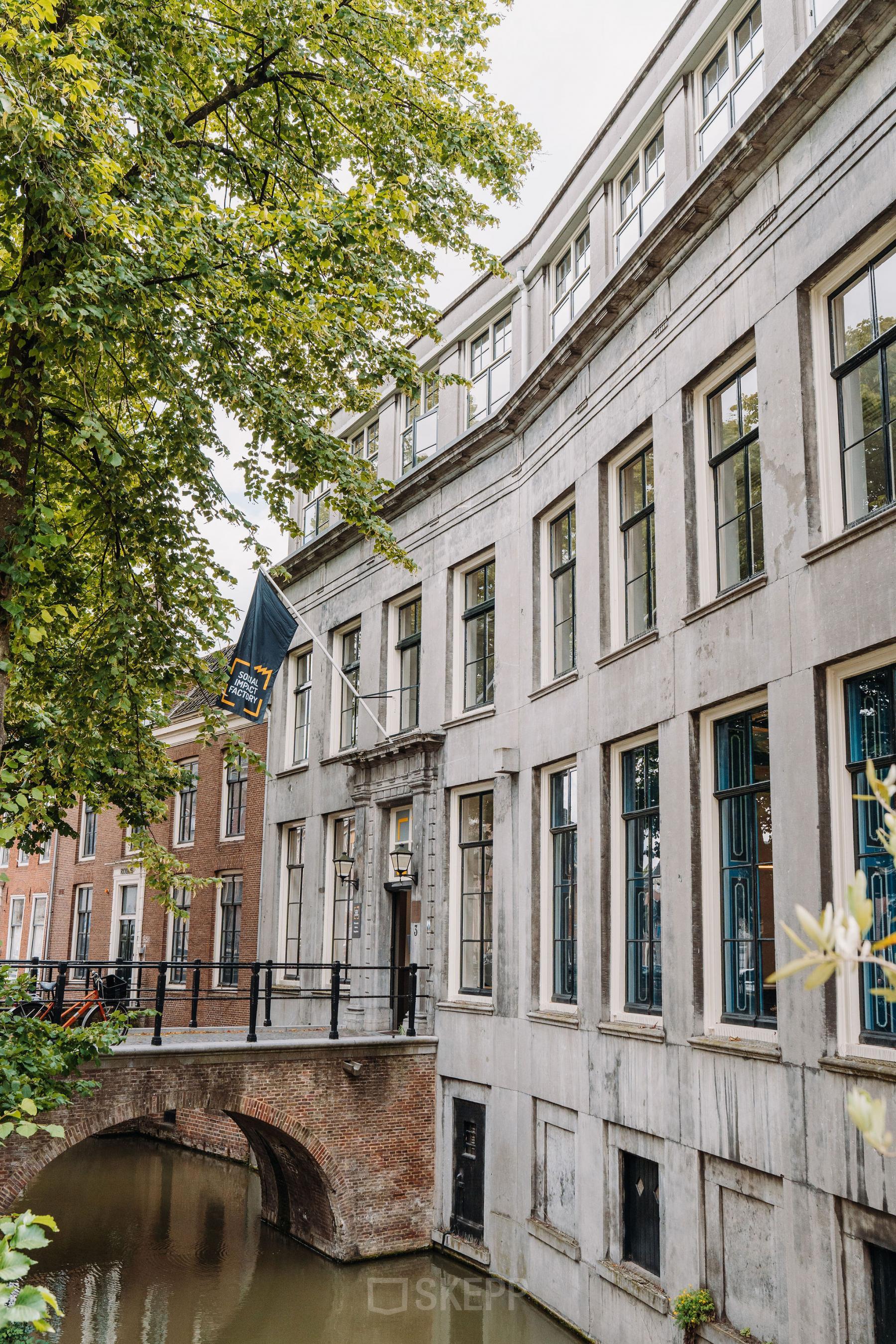 Exterior view of office building at Kromme Nieuwegracht 3, Utrecht Center. Historical architecture by a canal, office space rental available.