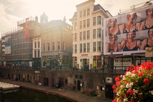 Exterior view of Oudegracht 161, Utrecht Center, featuring historic architecture along the canal with visible rental signage.