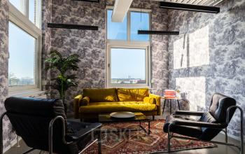 Cozy lounge space with modern furniture and large window overlooking city view at Nicolaas Beetsstraat 216, Utrecht Center.