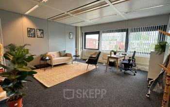 A furnished office at Bernadottelaan 13, Utrecht Kanaleneiland, featuring comfortable seating and a work desk, ideal for those seeking office space rental.