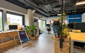 Bright office space at Bernadottelaan 13 in Utrecht Kanaleneiland, featuring modern furnishings, plants, and natural light. Ideal office to rent for productive work.