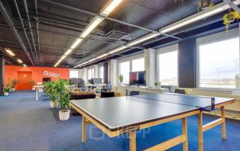 Bright, modern office space in Europalaan 400, Utrecht Kanaleneiland featuring a ping-pong table, workstations, and ample natural light, ideal for dynamic office space rental.