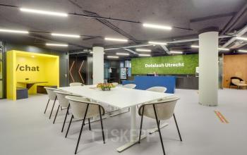 Modern office interior at Europalaan 400, Utrecht Kanaleneiland, featuring a sleek conference room perfect for office space rental, with a vibrant design and comfortable seating arrangement.
