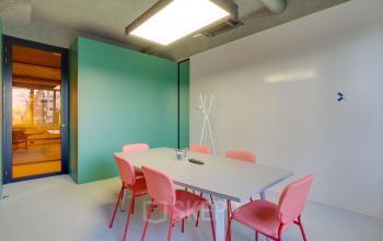 Bright office interior at Europalaan 400, Utrecht Kanaleneiland with modern furniture and colorful chairs. Perfect for office space rental.