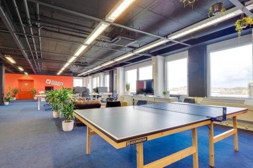 Bright, modern office space in Europalaan 400, Utrecht Kanaleneiland featuring a ping-pong table, workstations, and ample natural light, ideal for dynamic office space rental.