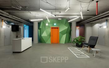 Modern and creative office space in Utrecht Kanaleneiland at Europalaan 100, featuring contemporary furnishings and vibrant geometric wall design, suitable for office space rental.